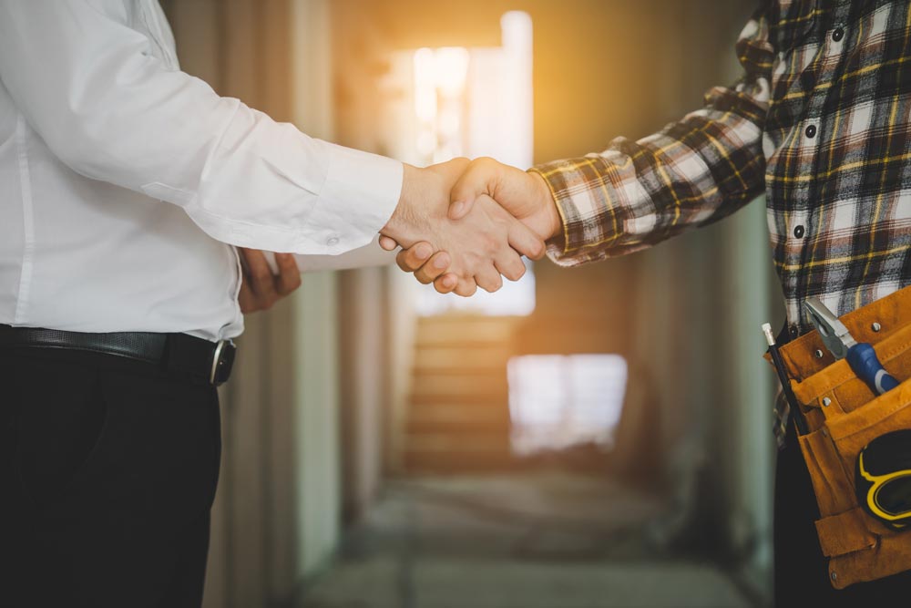 home inspector shaking hands with client